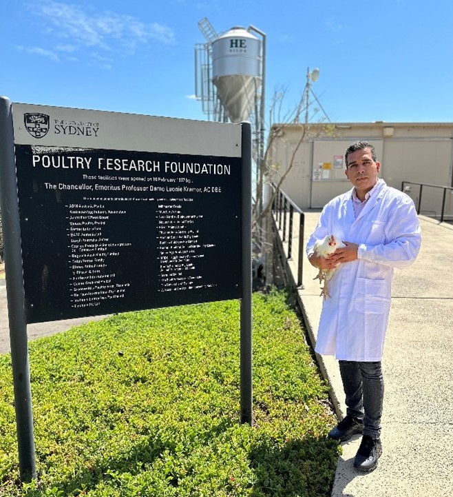 Photo of Dr Mehdi Toghyani holding a chicken.