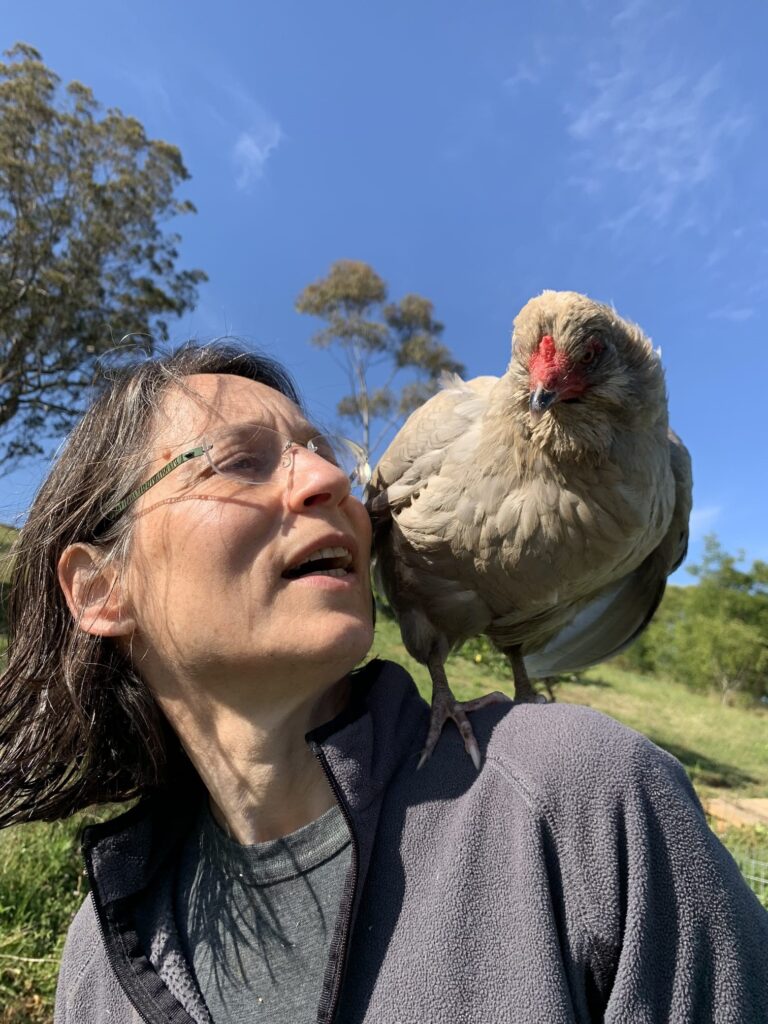 Ruth Zadoks with a chicken on her shoulder.